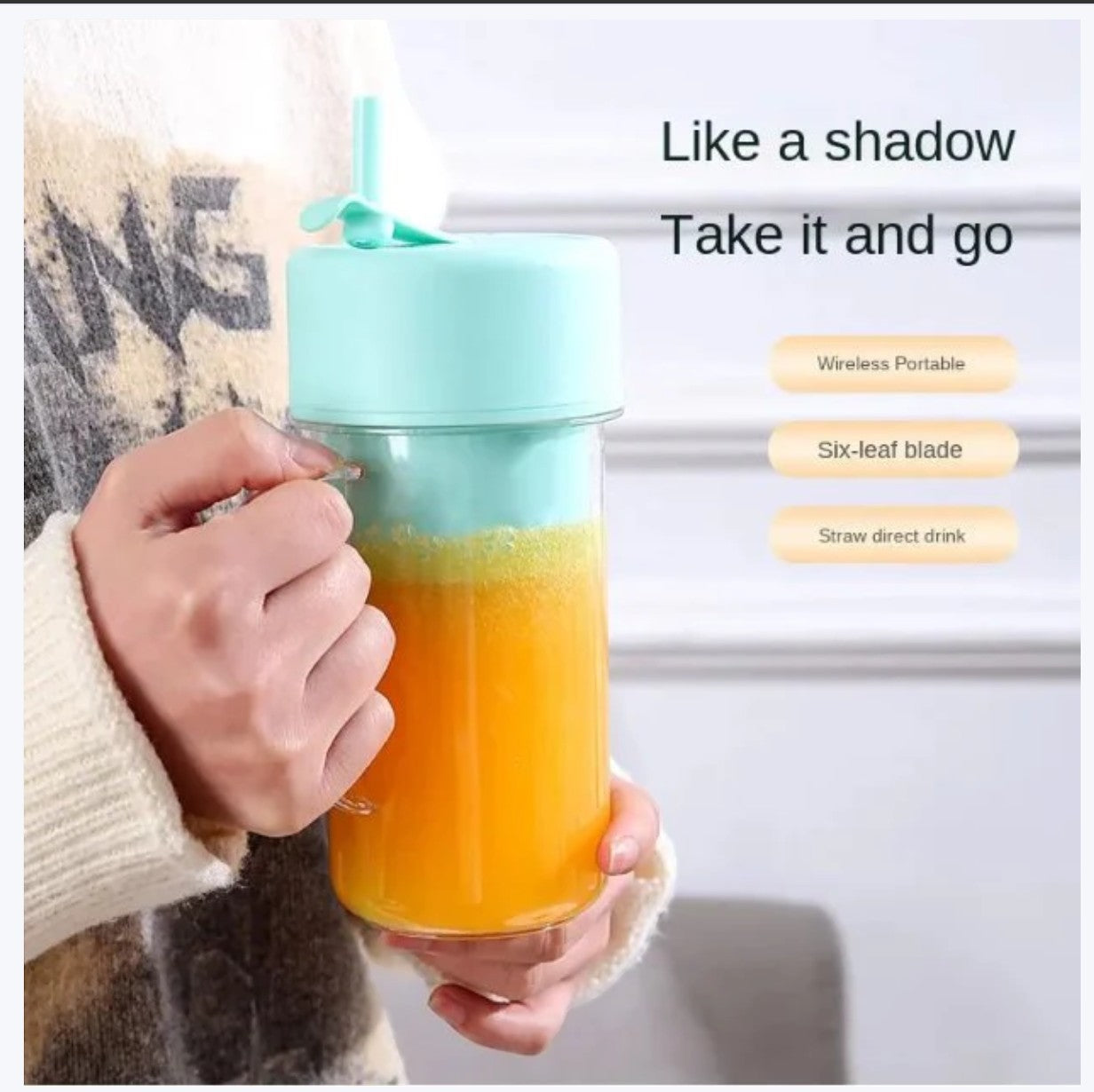 JHATPAT portable personal smoothie blender in pastel mint green with a straw, filled with orange juice.